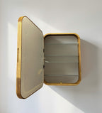A rectangular wall-mounted wooden storage cabinet with an open hinged door, featuring three glass shelves inside, shown against a plain white wall.