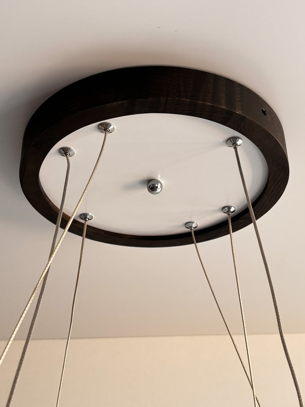Black wood ring LED pendant light over dining table — photo 4