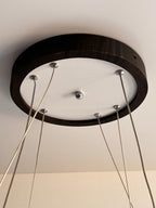 Black wood ring LED pendant light over dining table — photo 4