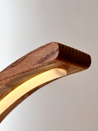 Arc wood LED table lamp with touch dimmer on bedside table — photo 11