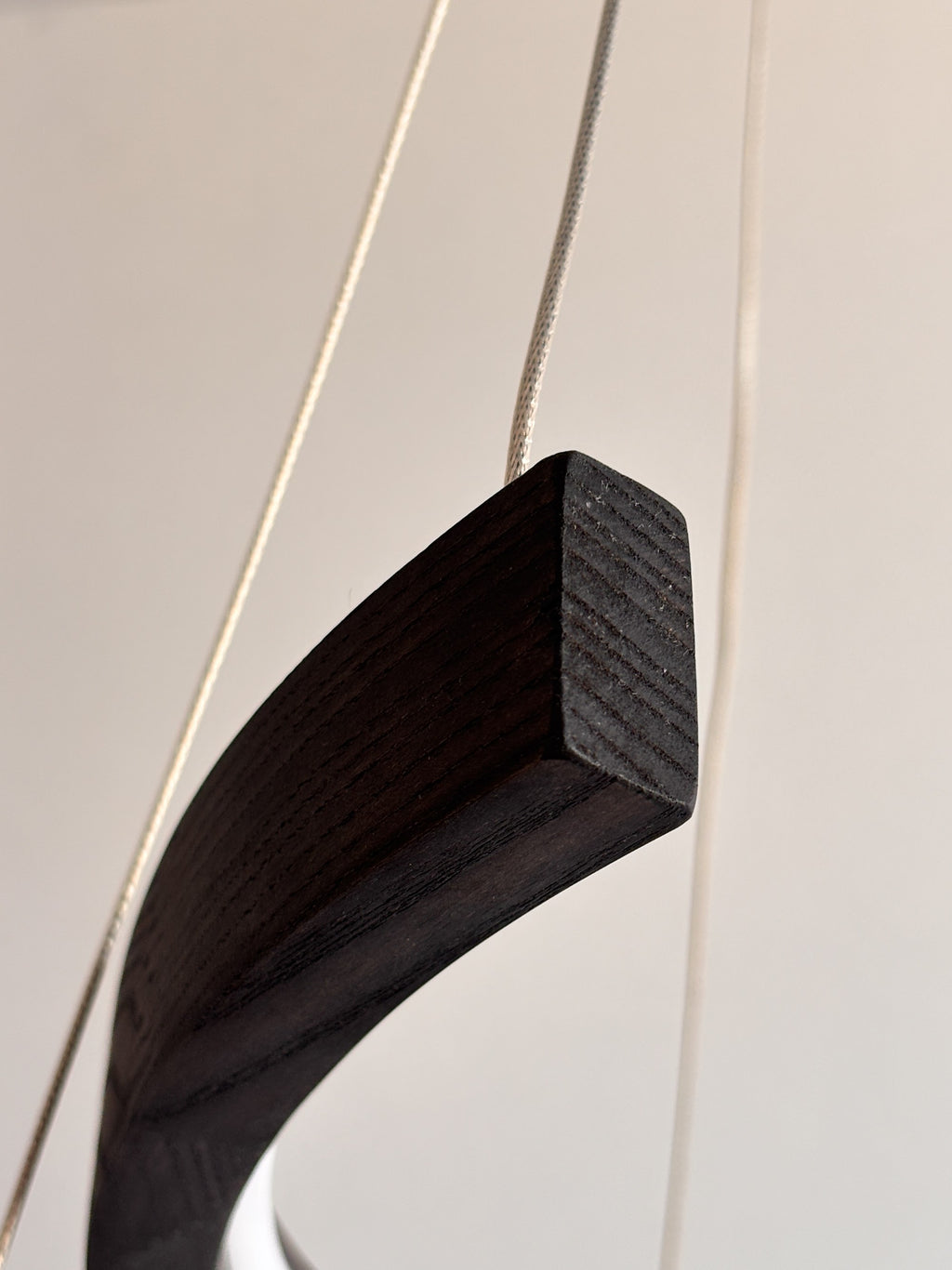 Black wood ring LED pendant light over dining table — photo 5