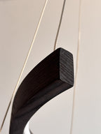 Black wood ring LED pendant light over dining table — photo 5