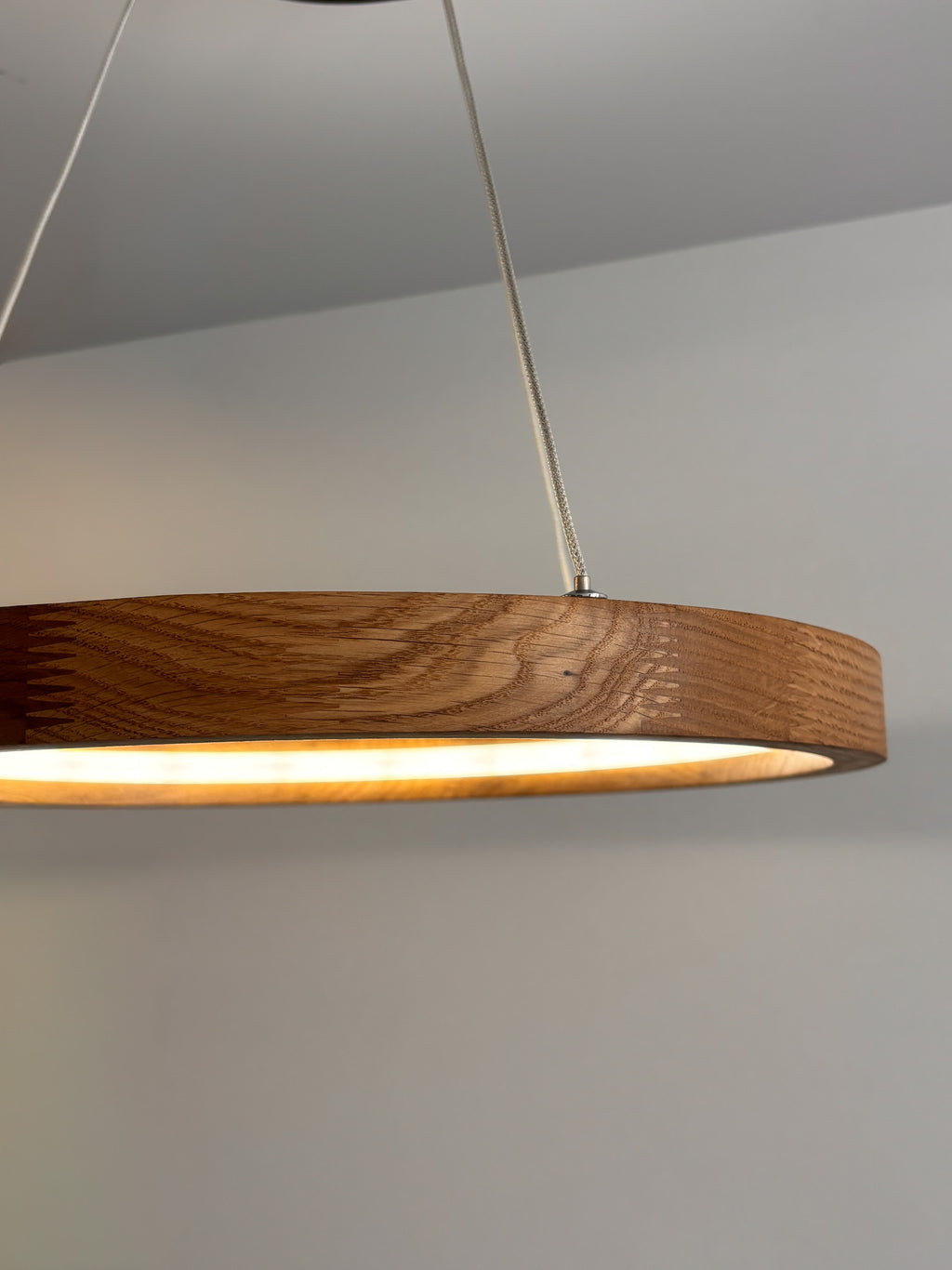 Oak ring LED pendant light with black canopy over kitchen island — photo 10