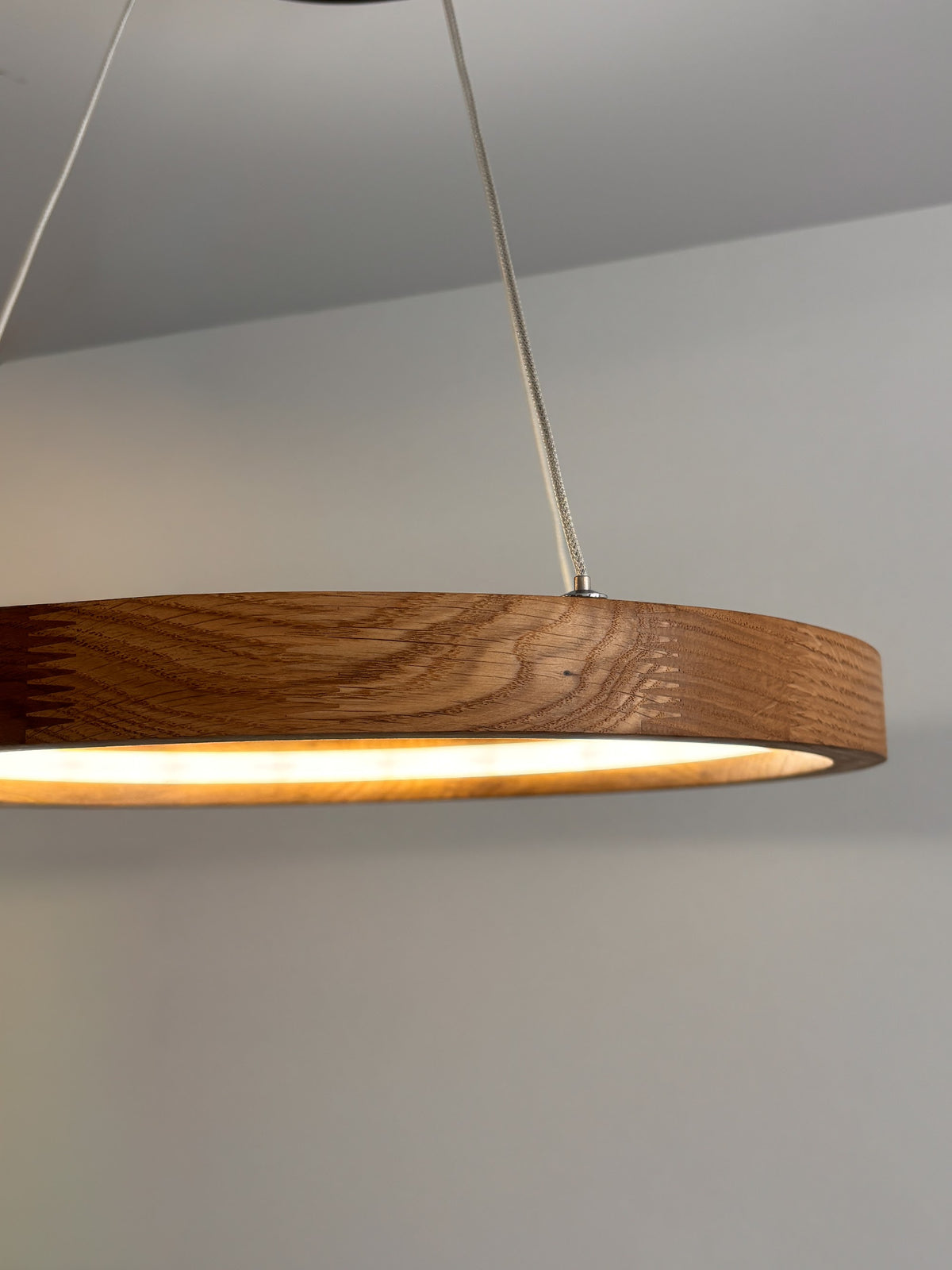 Oak ring LED pendant light with black canopy over kitchen island — photo 10