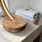Arc wood LED table lamp with touch dimmer on bedside table — photo 9