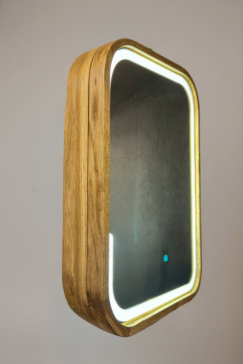 A rectangular wall mirror with rounded corners, featuring a natural wood grain frame and a glowing white LED light border, shown against a neutral gray background.