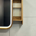Close-up of a wooden wall-mounted shelf or cabinet side panel with two open shelves, shown against a light gray tiled wall.