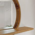 A close-up of a modern floating wooden shelf with a curved backrest, made from natural oak wood with visible grain, set against a white wall and a marble-tiled background.