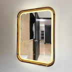Angled view of the square LED bathroom mirror with the light on