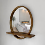 Wooden wall mirror with shelf reflecting a living room.