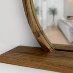 Wooden mirror with a shelf on a white wall