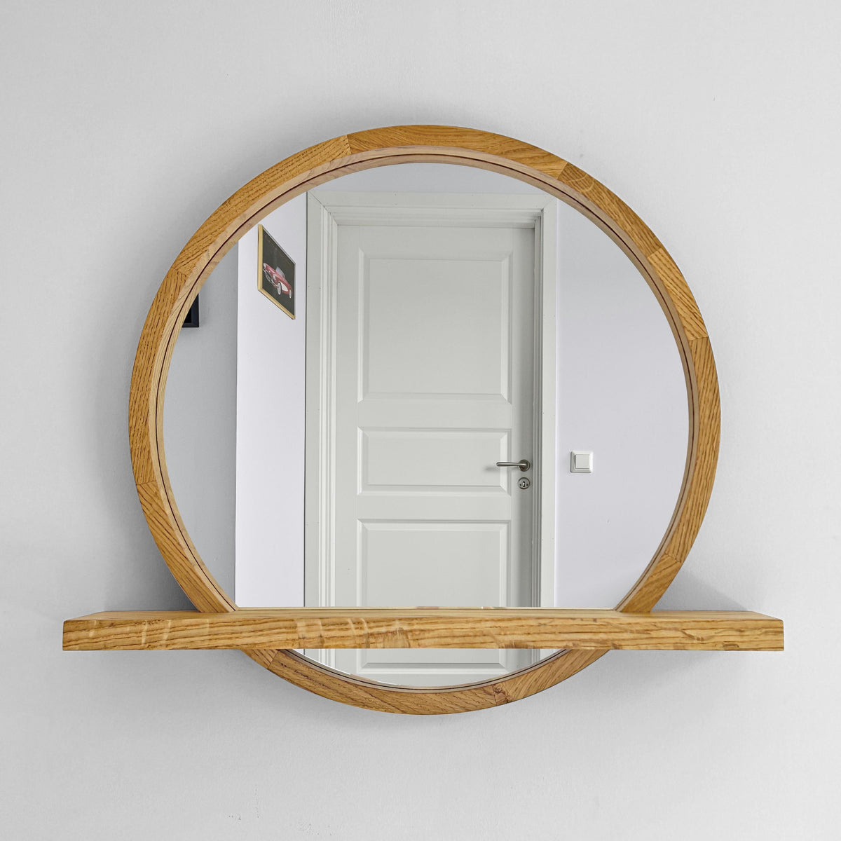 Handmade round wood wall mirror with a built-in shelf