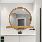 Round mirror with shelf in a bathroom