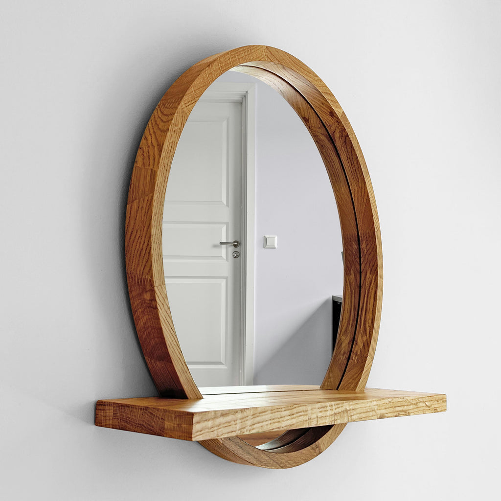 Round wood mirror with shelf mounted in an entryway