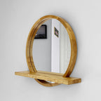 Angled view of the mirror and shelf in solid wood