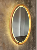 Oval LED wood mirror on a textured wall
