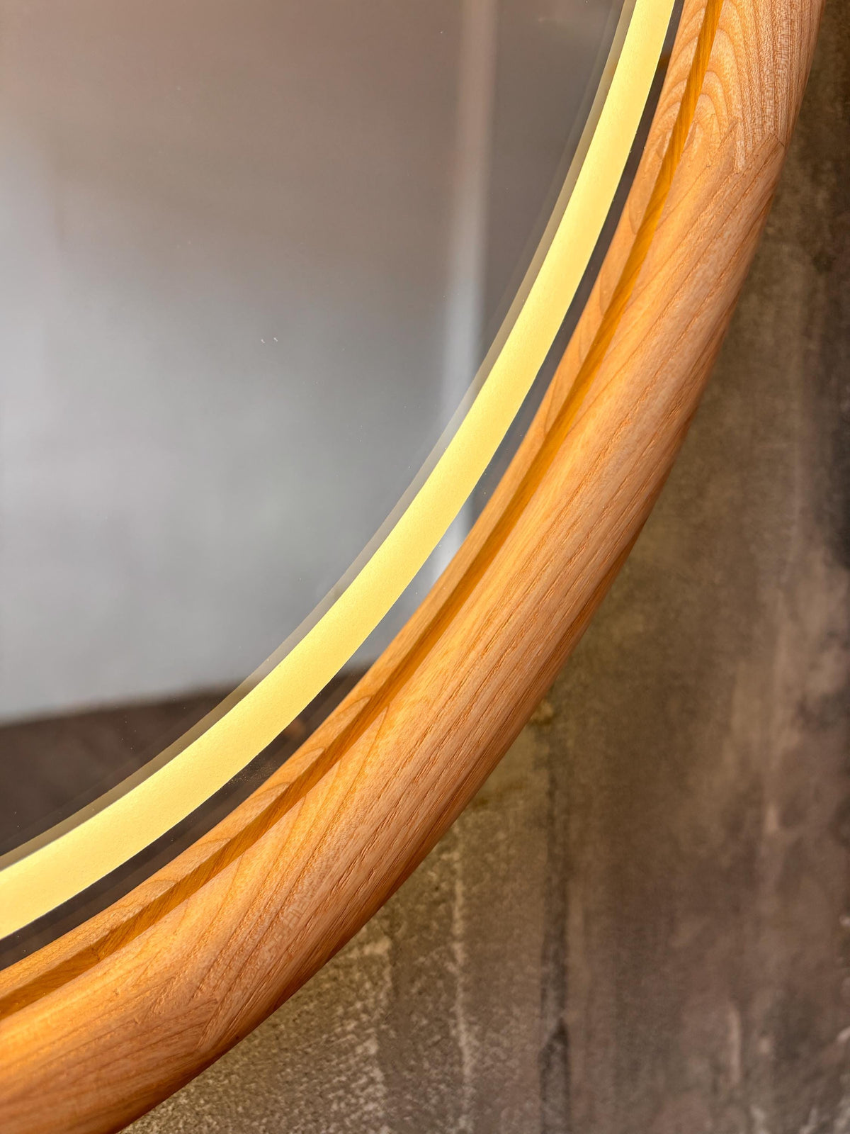 Detail of the rounded wooden edge of the oval mirror