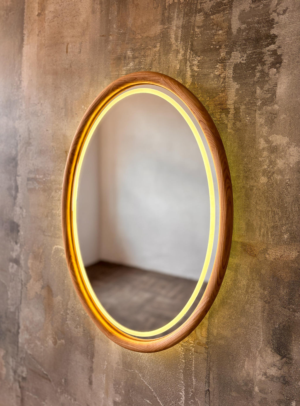 Oval wood mirror with the LED light switched on