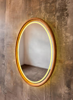 Oval wood mirror with the LED light switched on