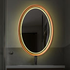 Oval mirror with soft LED glow above a vanity