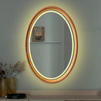 Oval LED wood mirror with warm light on a wall