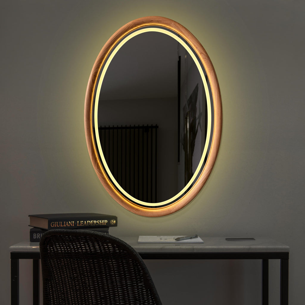 Oval LED mirror lighting a dark room