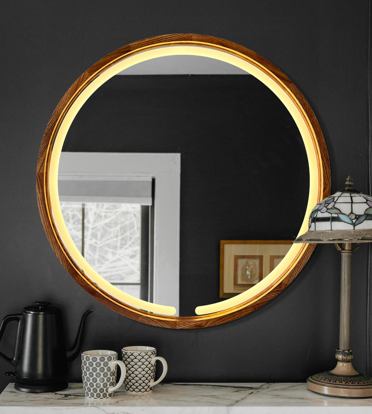 Round LED wood mirror in a dark bathroom interior