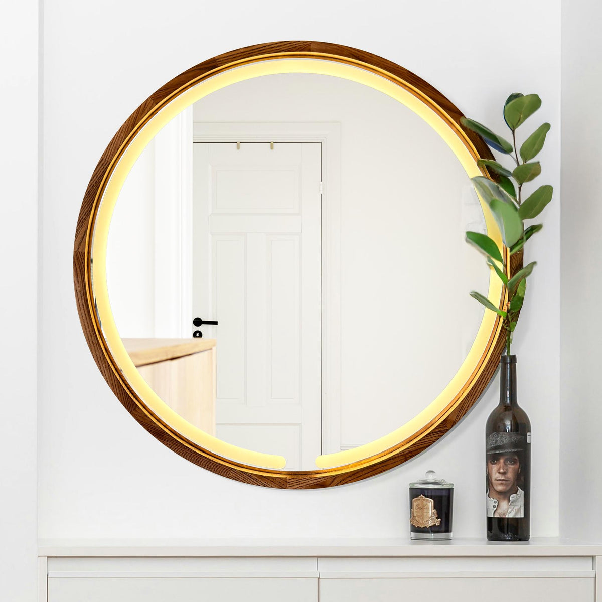 Round LED mirror lighting a bathroom wall