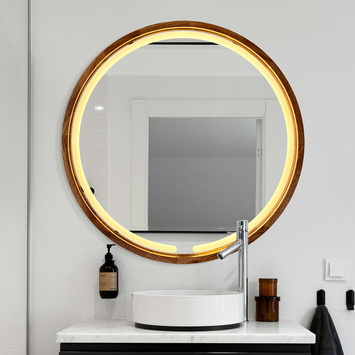 Round LED wood mirror over a stone basin