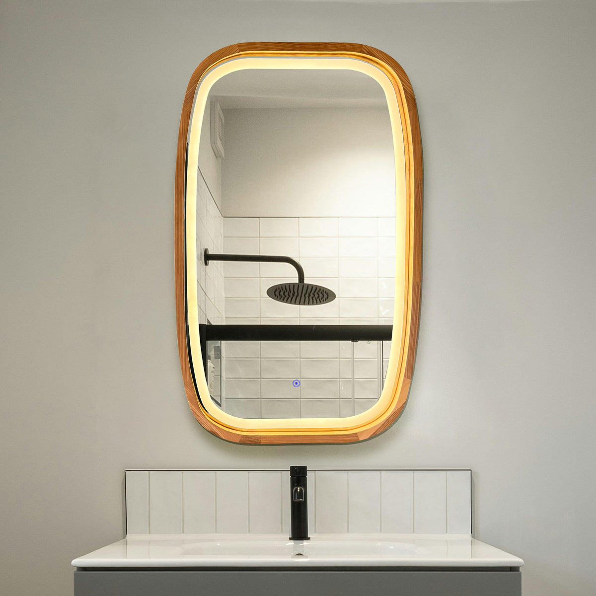 Rounded rectangle LED wood mirror above a bathroom basin