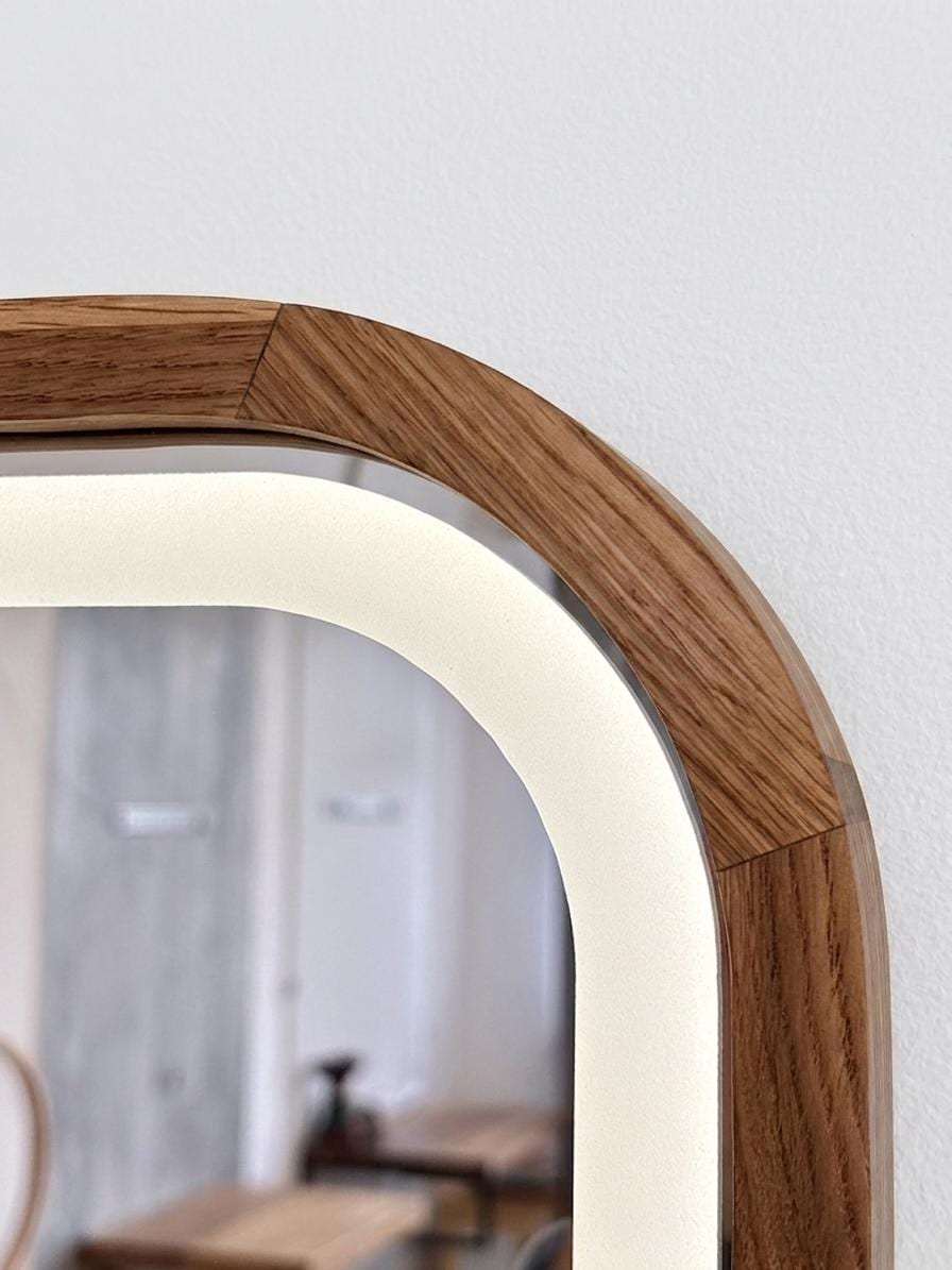 Close-up of the mirrored door with warm LED light