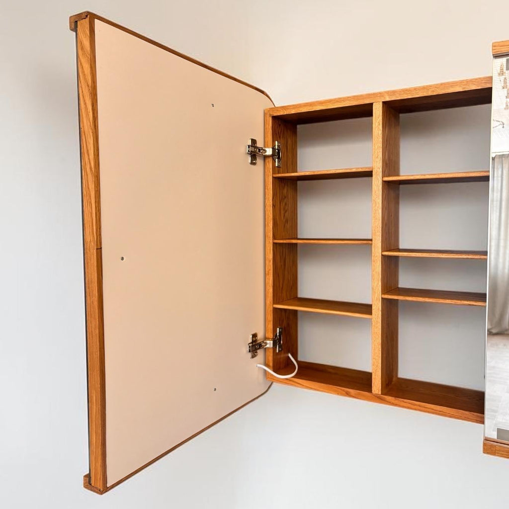 Open cabinet seen from the side with lighted doors