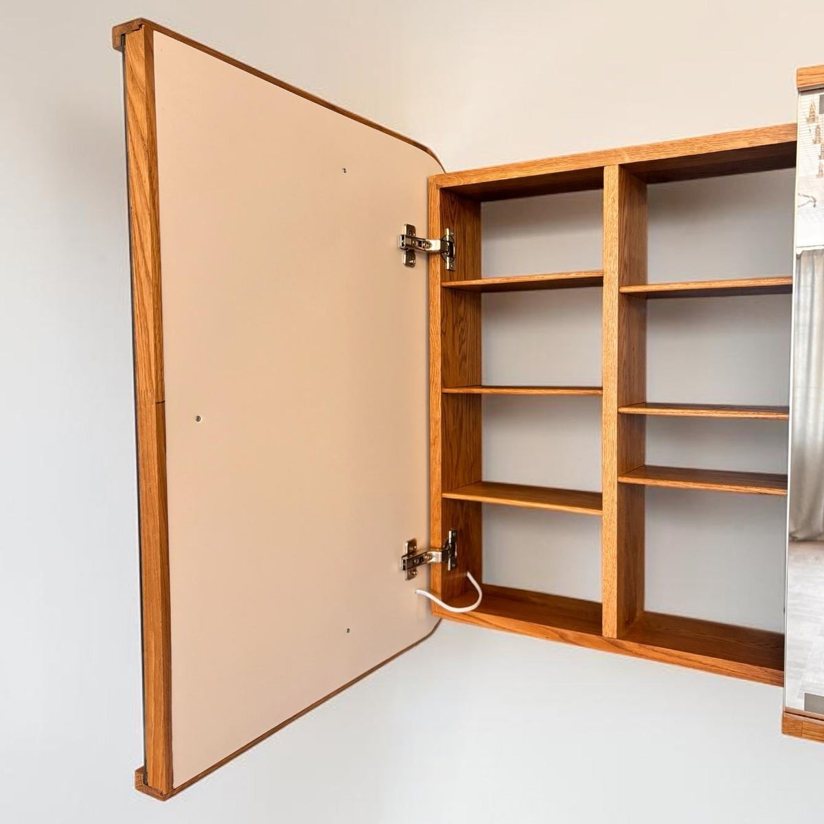 Open cabinet seen from the side with lighted doors