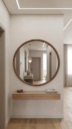 Round mirror cabinet in solid wood above a floating console in a hallway