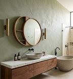 Round wood mirror with shelf above a bathroom vanity
