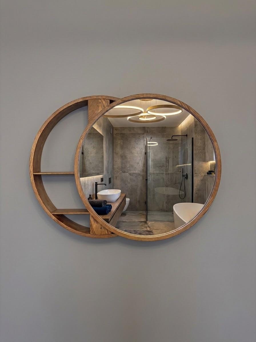 Round mirror with crescent shelving mounted on a wall