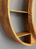 Side view showing the open shelves behind the round wood frame