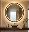 Round LED wood mirror with warm light above a bathroom vanity