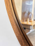 Close-up of the wood grain on the round mirror frame