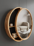 Round wood mirror with an integrated crescent shelf holding skincare jars
