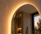 Close-up of the frameless arch mirror edge and backlight