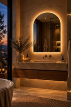 Arched LED vanity mirror in a bathroom at night