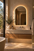 Arch backlit LED bathroom mirror over a stone vanity